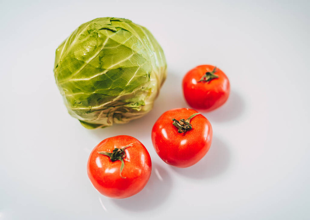 Cubbage and tomatoes on white background. Organic food concept. Stay healthy. Fresh products consuming. - Foto, Imagem