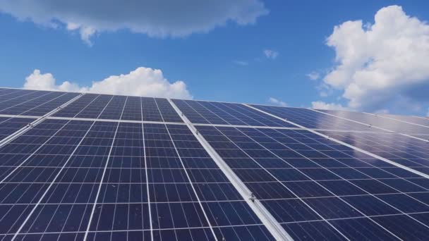 Solar photovoltaic panels on the roof against the blue sky with clouds. - Video, Çekim