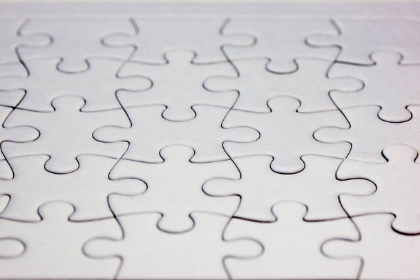 Close-up biały puzzle z wszystkich elementów połączonych - pełna ramka - Zdjęcie, obraz