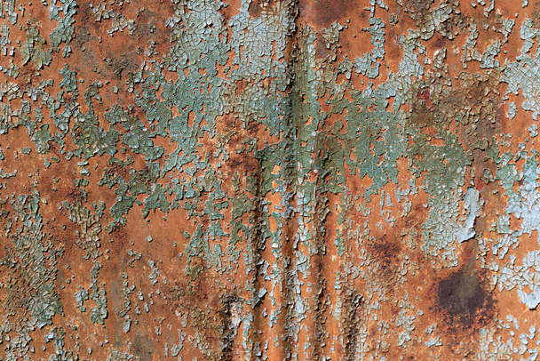 Aqua green paint, checked and crazed, flaking off a rusty metal background, horizontal aspect - Photo, Image
