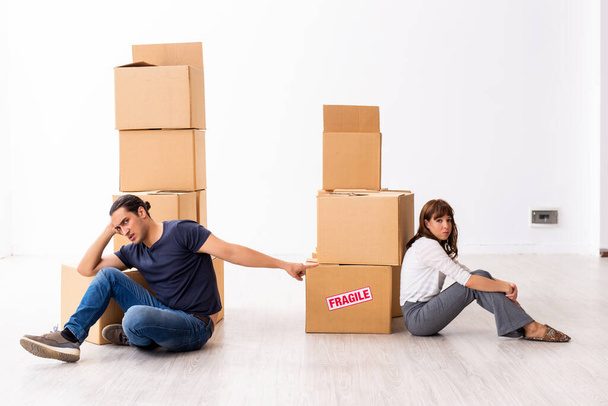 Young pair and many boxes in divorce settlement concept - Photo, Image