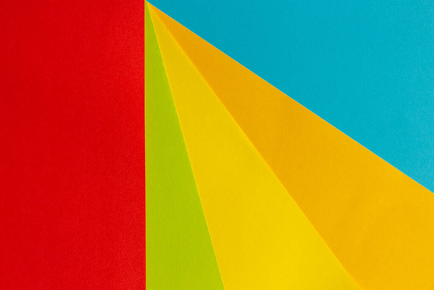 Yellow, blue, red, multi color paper geometric flat lay background - Foto, Imagem