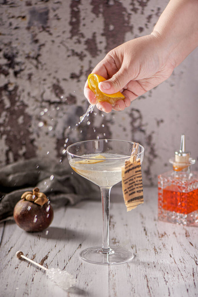 Cocktail and mixology. Glass of ocktail. Hand of barman. - Zdjęcie, obraz