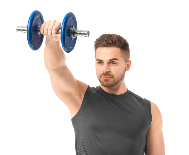 Sporty young man training with dumbbells on white background - Fotoğraf, Görsel