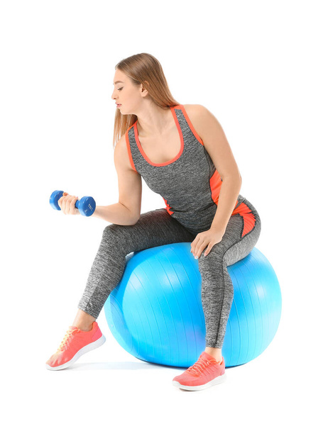 Sporty young woman training with dumbbells on white background - Φωτογραφία, εικόνα