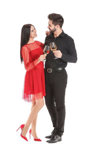 Happy couple with glasses of champagne on white background - Photo, Image