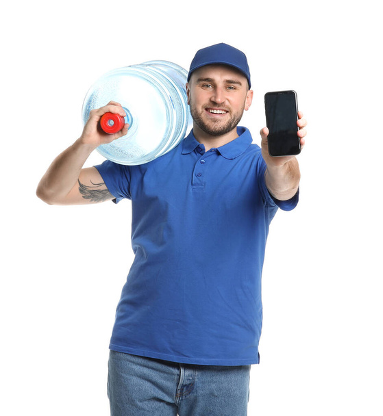 Delivery man with bottle of water and mobile phone on white background - Photo, Image