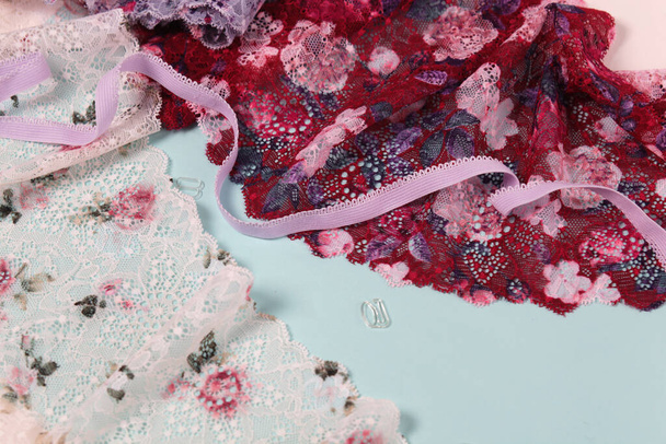 Abstract background with pile of color rich bright lace for Lingerie, panties, and bras. Delicate sophisticated glamorous elastic material. Using for Atelier and fabric store. - Photo, Image