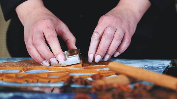 Slow motion of womans hands using cookie cutter to make cookies - Photo, Image