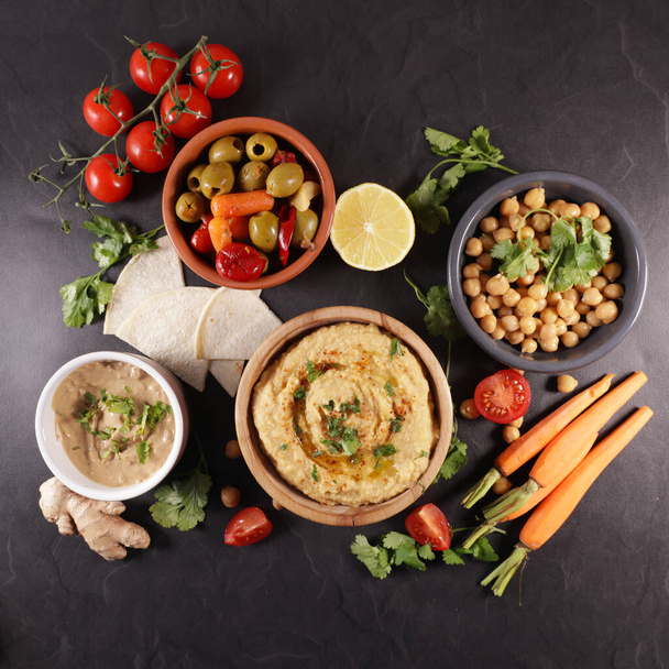 hummus, olive and sauce with vegetable - Fotoğraf, Görsel