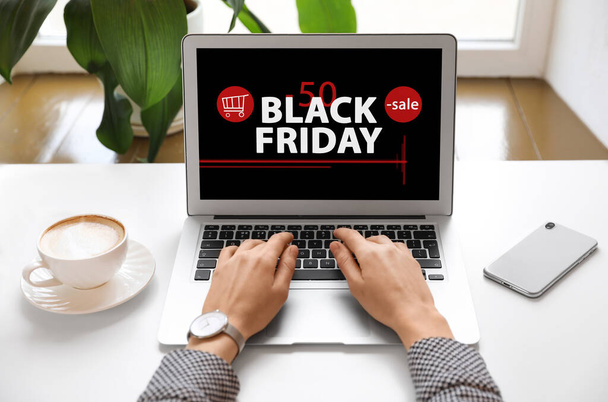 Black Friday. Woman shopping online using laptop at table, closeup - Фото, изображение