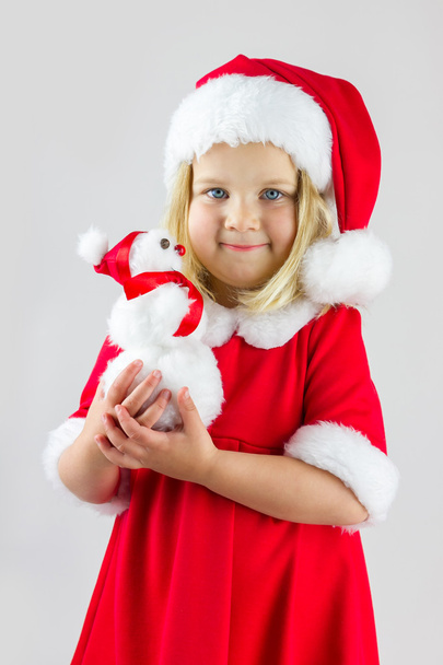 Sweet girl in a red Christmas costume - 写真・画像