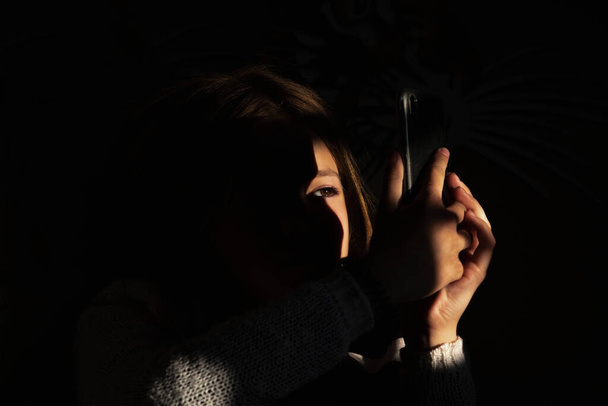 Portrait photo of a young girl on a dark background - Fotoğraf, Görsel