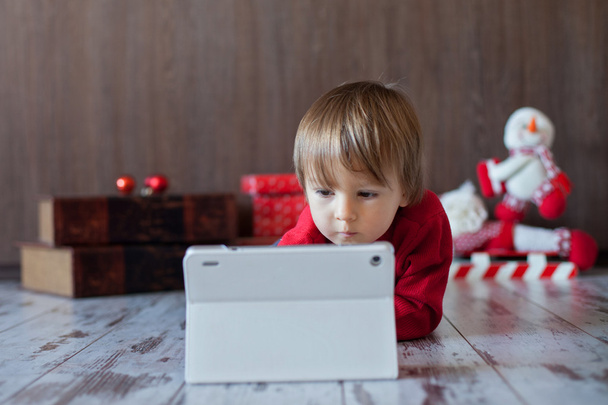 Little boy playing on tablet - Photo, image