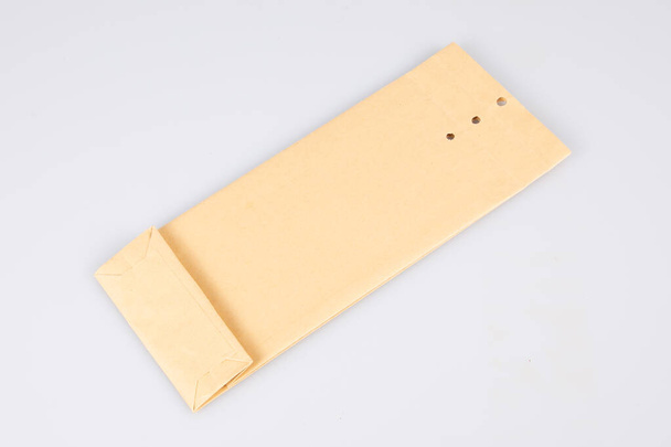 Kraft küçük kahverengi kağıt kare delikli kapama zarfı izole - Fotoğraf, Görsel