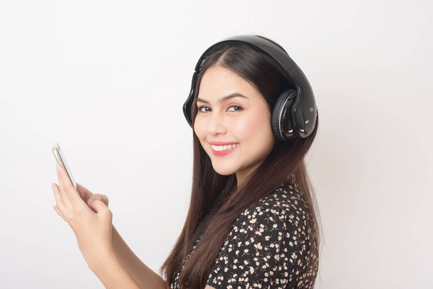 Music lover woman is enjoying with headset on white background  - Zdjęcie, obraz