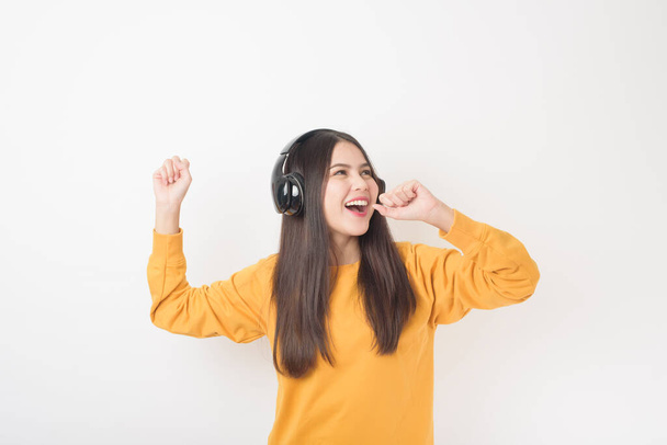 Music lover woman is enjoying with headset on white background  - 写真・画像