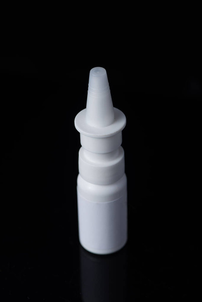 Witte plastic medische container op witte, zwarte achtergrond - Foto, afbeelding