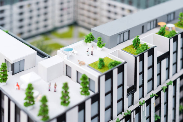 Miniature model, miniature toy buildings, cars and people. City maquette. New building project. - Фото, изображение