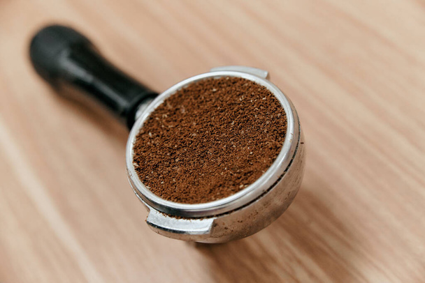 Freshly ground coffee in the holder for making a portion of coffee in the coffee machine - Fotografie, Obrázek
