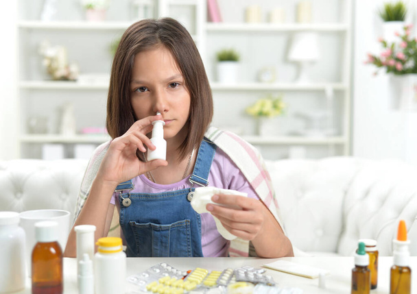 Close up portrait of sick  little girl using inhaler  - Foto, imagen