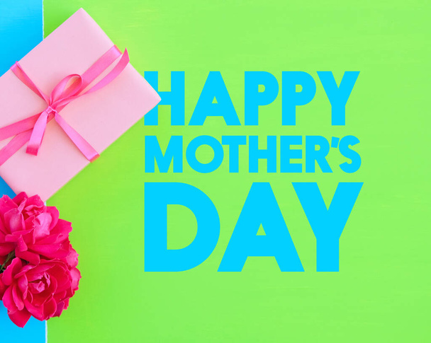 Happy Mother's day card shows top view of gift box on bright background. - Foto, imagen