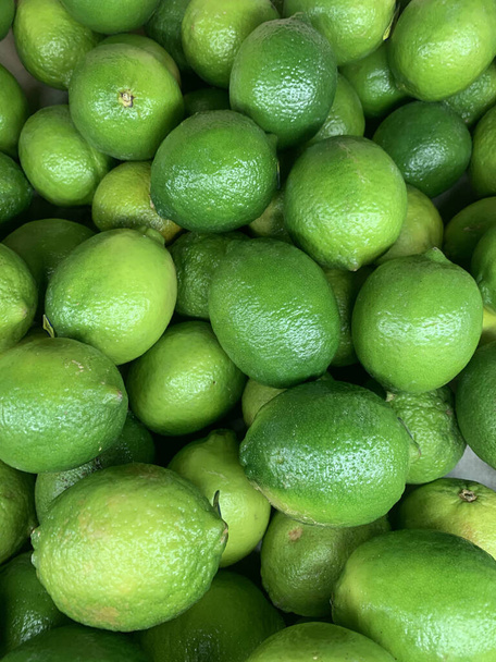 lots of ripe green limes for cooking a background - Photo, Image