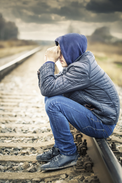 Sorrowful boy on the railway - Photo, Image