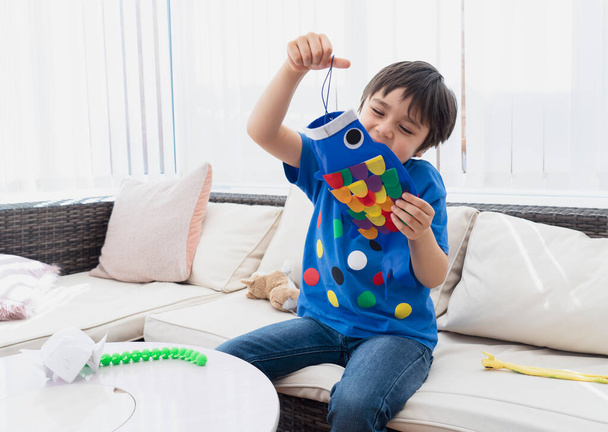 High key Portrét happy kid stay at home making coloufull Koinobori (Carp streamers), Child boy doing Japanese fish kite in sunny day summer, Distance education or Home schooling, Children 's Day  - Fotografie, Obrázek