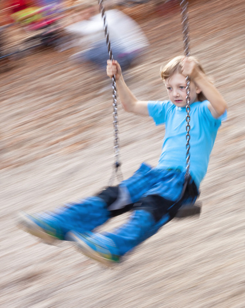 Boy on a Swing in the Playground - Valokuva, kuva