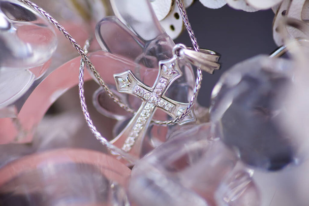 Christian cross to wear on the body after baptism. Material-silver. The concept of faith and religion. - Photo, Image