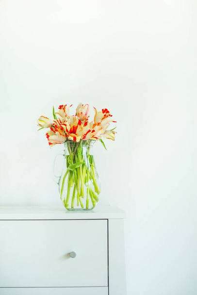 Home interior design with bunch of tulips and vase. Springtime concept - Photo, image