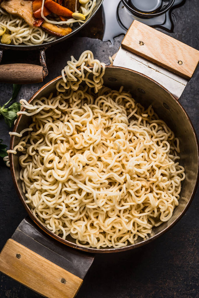 Pot with cooked asian noodles on rustic kitchen table, top view - Fotoğraf, Görsel