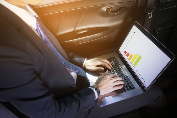 Business man is working with laptop in the car - 写真・画像