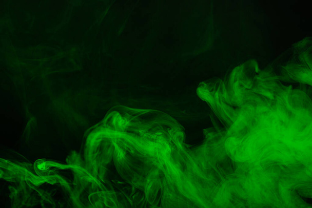 Green steam on a black background. Copy space. - Fotó, kép