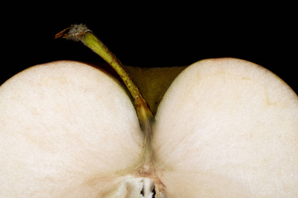 seasonal apple in cross section with peduncle close up on a black background - Foto, immagini