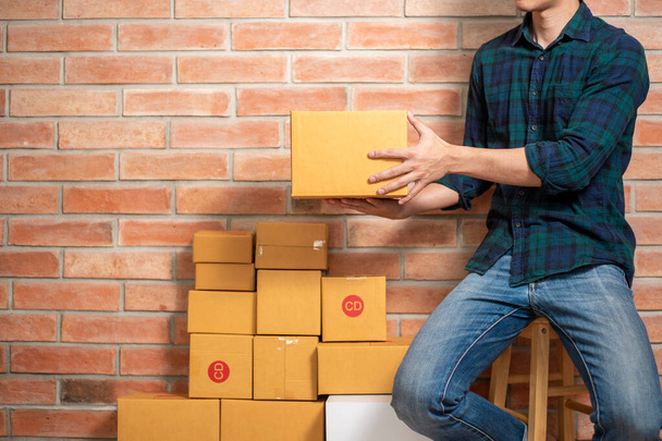 A man entrepreneur owner SME business is packaging box to send his customer - Fotó, kép