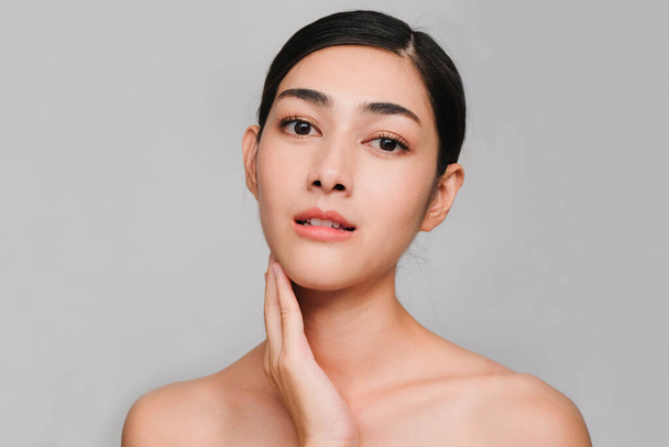 Beautiful asian woman ,young asian girl with clean and bright skin, Cosmetic Beauty Concept,hands touch on the cheek,smily and friendly face isolated on grey background - Φωτογραφία, εικόνα