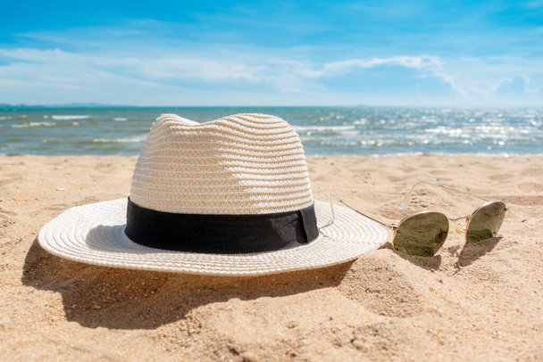 White hat and sunglasses on beach, Summer concept  - Fotó, kép