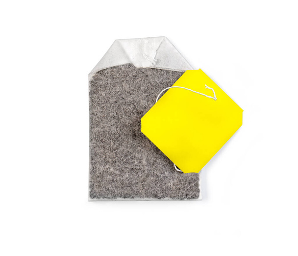 Teabag with yellow label. Top view. Isolated on a white. with clipping path - Fotografie, Obrázek