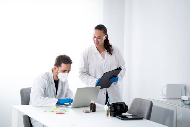 Young Male and Female Doctors or scientists working in the modern biological and biotechnology science laboratory. - Fotoğraf, Görsel