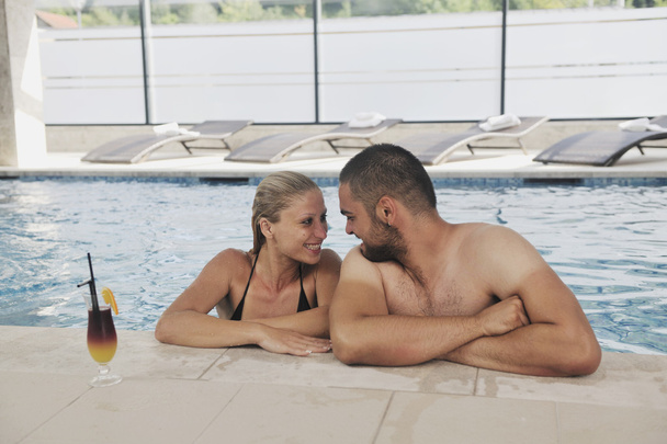 Happy cople relaxing at swimming pool - Photo, Image