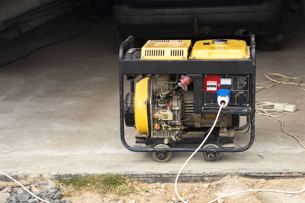 stand-alone diesel generator to supply electricity in an emergency. Yellow color. Serves not a large residential building. - Photo, Image