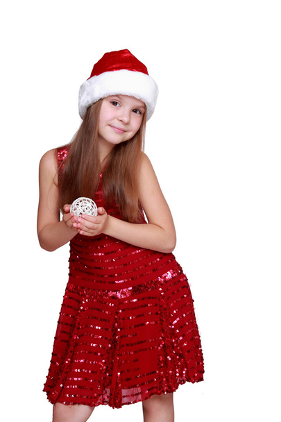 Girl holding Christmas decoration in hands - Foto, afbeelding