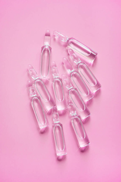 Ampoules with medicine on pink background. Pharmaceutical, cure. - Fotó, kép
