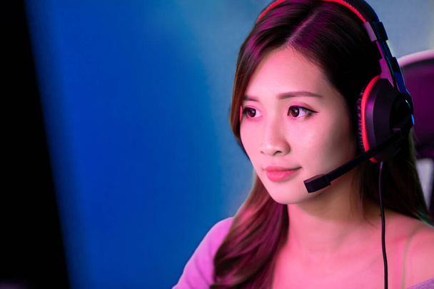 close up of Young Asian Pro Gamer Girl Playing in Online Video Game at home - 写真・画像