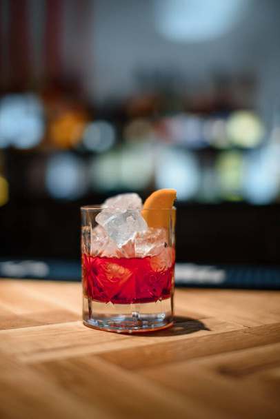 red alcohol cocktail on dark bar - 写真・画像