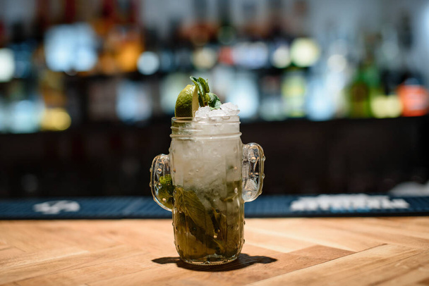 green lime alcohol cocktail on dark bar - 写真・画像