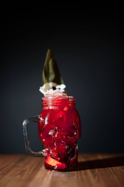 skull glass red alcohol cocktail on dark bar - 写真・画像
