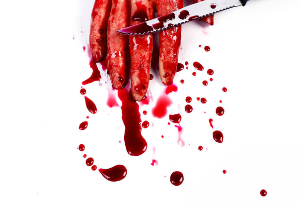 血を垂らした拳を作る血の手は白い上に隔離された. - 写真・画像